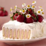 Easy no bake strawberry icebox cake decorated with fresh strawberries feature photo.