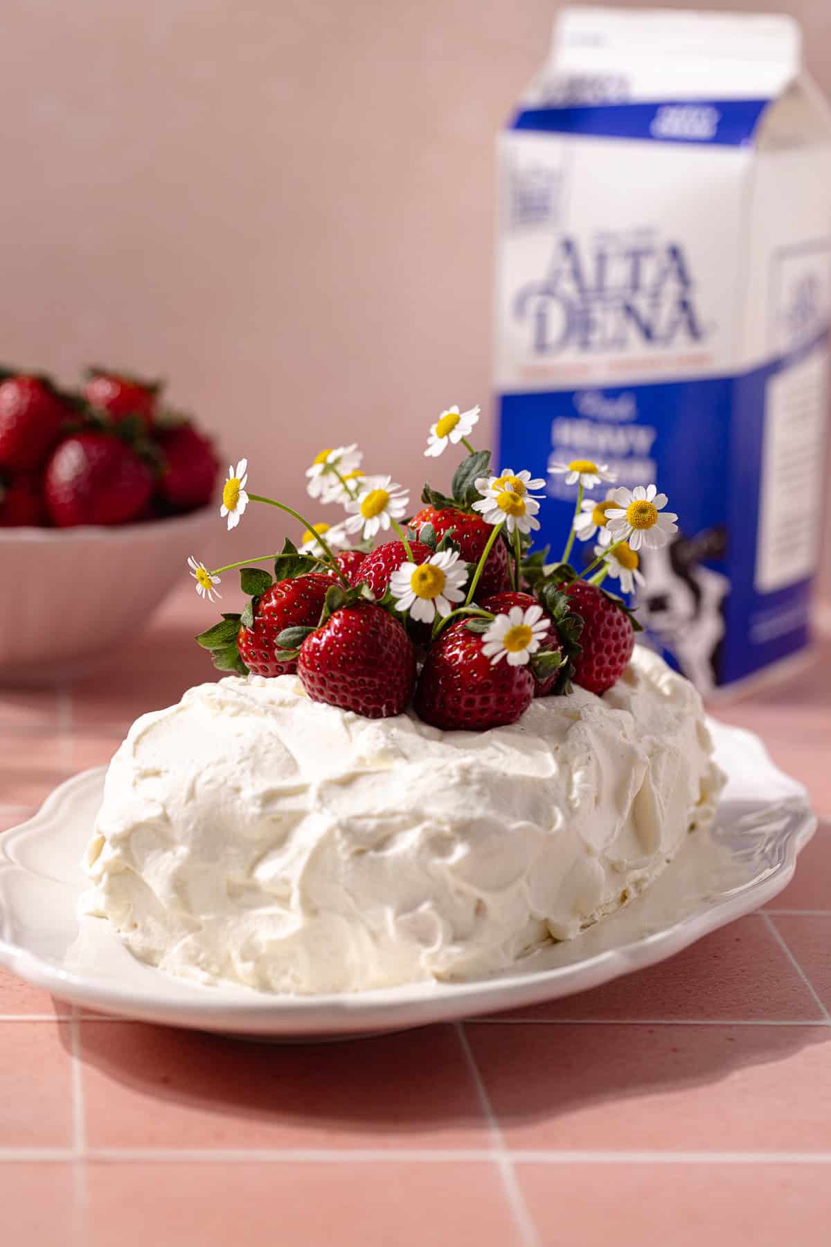 Strawberry icebox cake decorated with fresh strawberries on a serving platter.