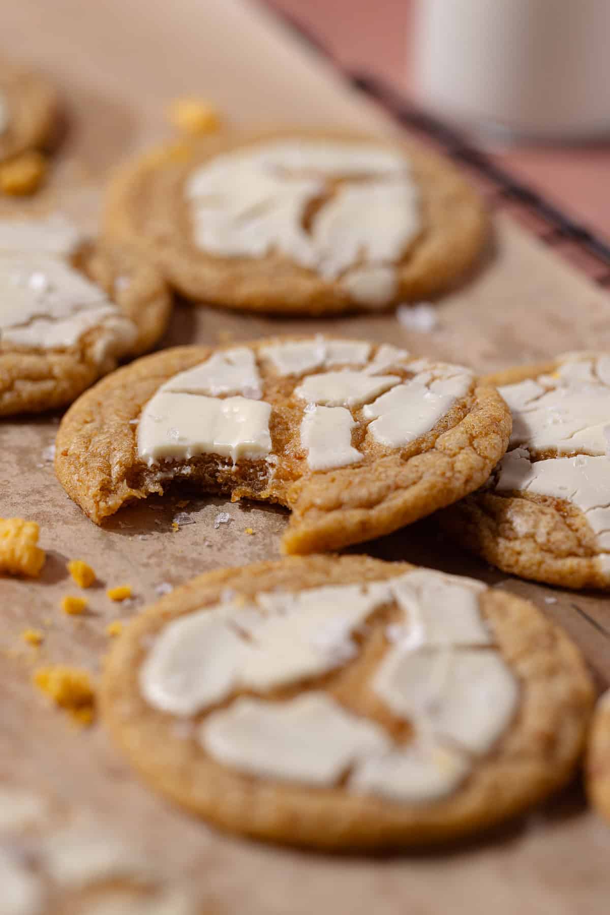 Captain Crunch cookies topped with white chocolate sitting on a wire rack.