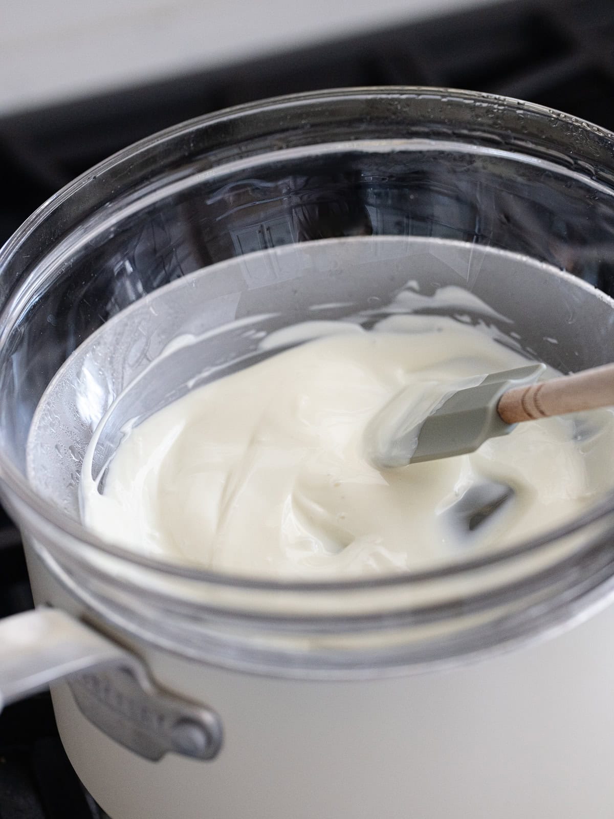 White chocolate is melted on the store top.