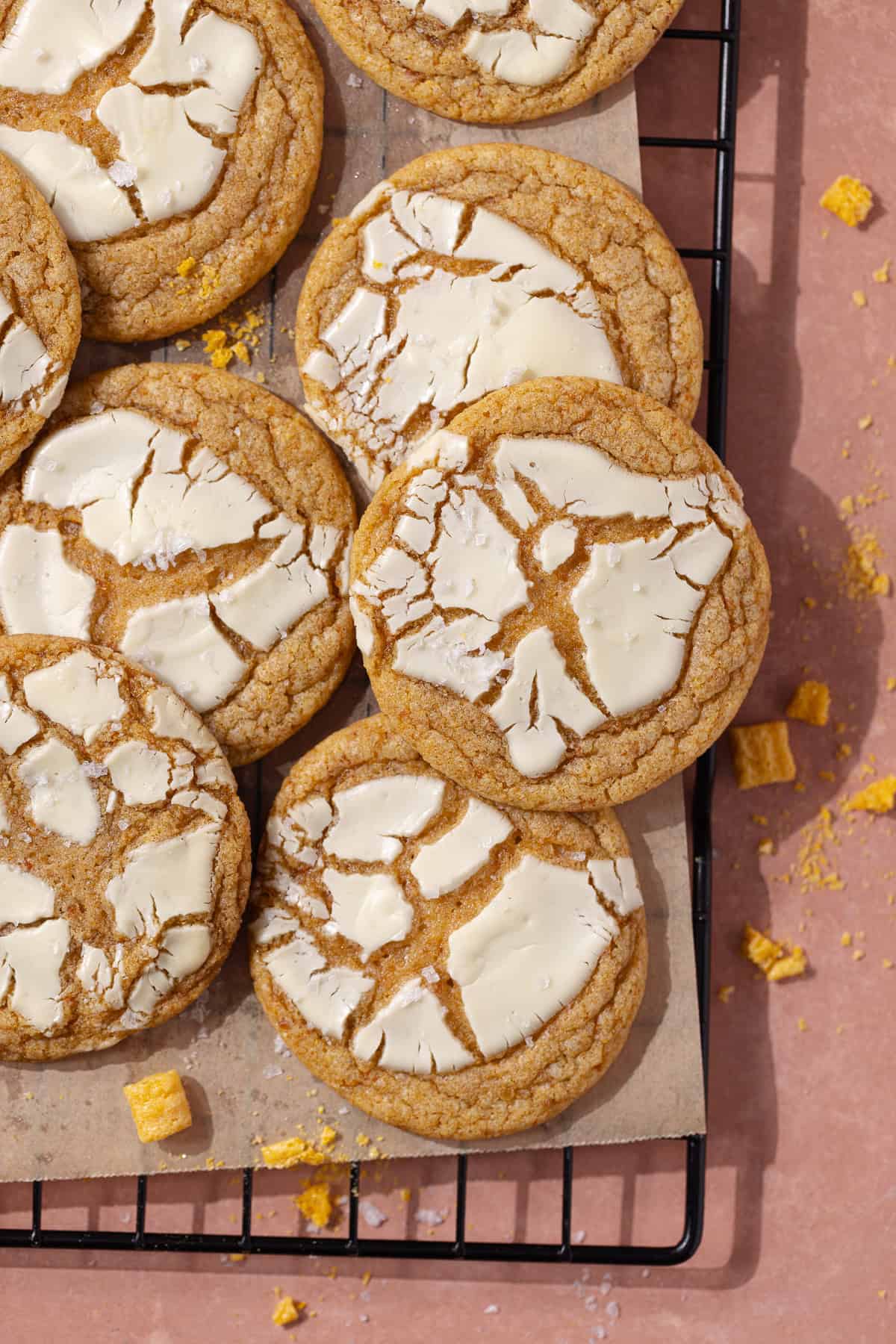 Captain Crunch cookies topped with white chocolate sitting on a wire rack.