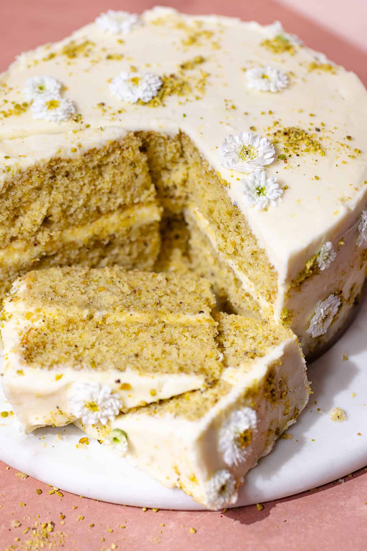 Pistachio Lemon cakes sliced sitting on a dessert plate.