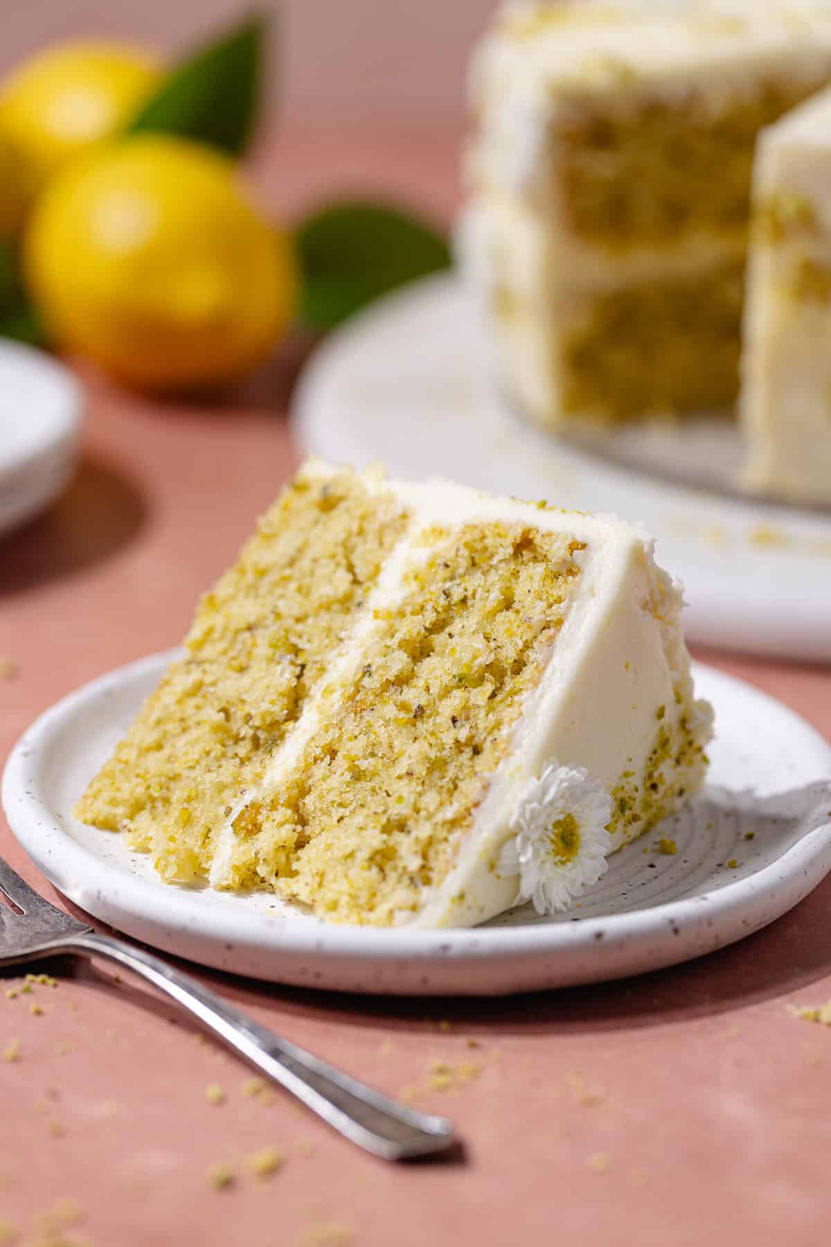 A slice of pistachio lemon cake on a dessert plate.