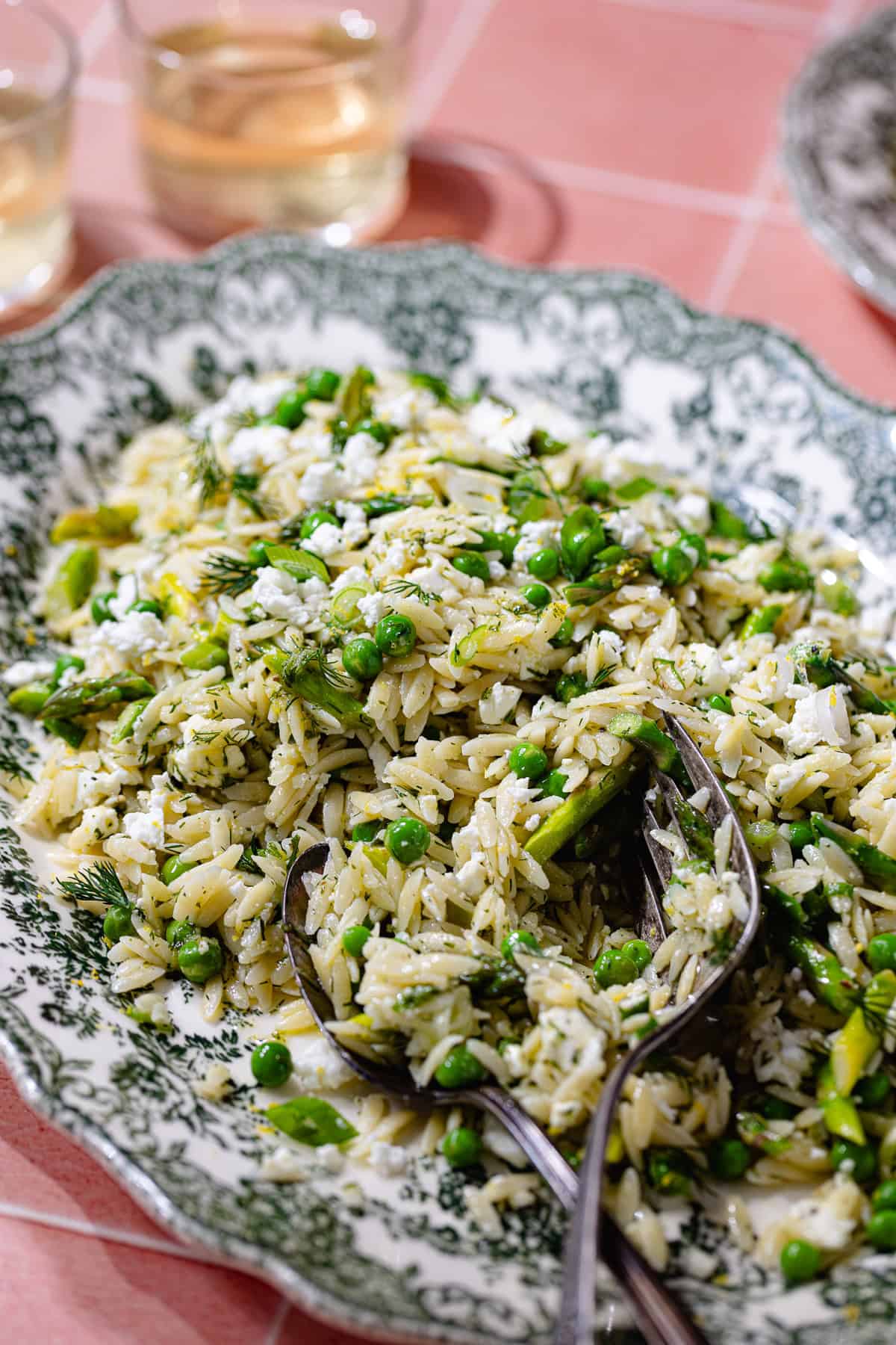 Spring orzo pasta salad in a serving plate.