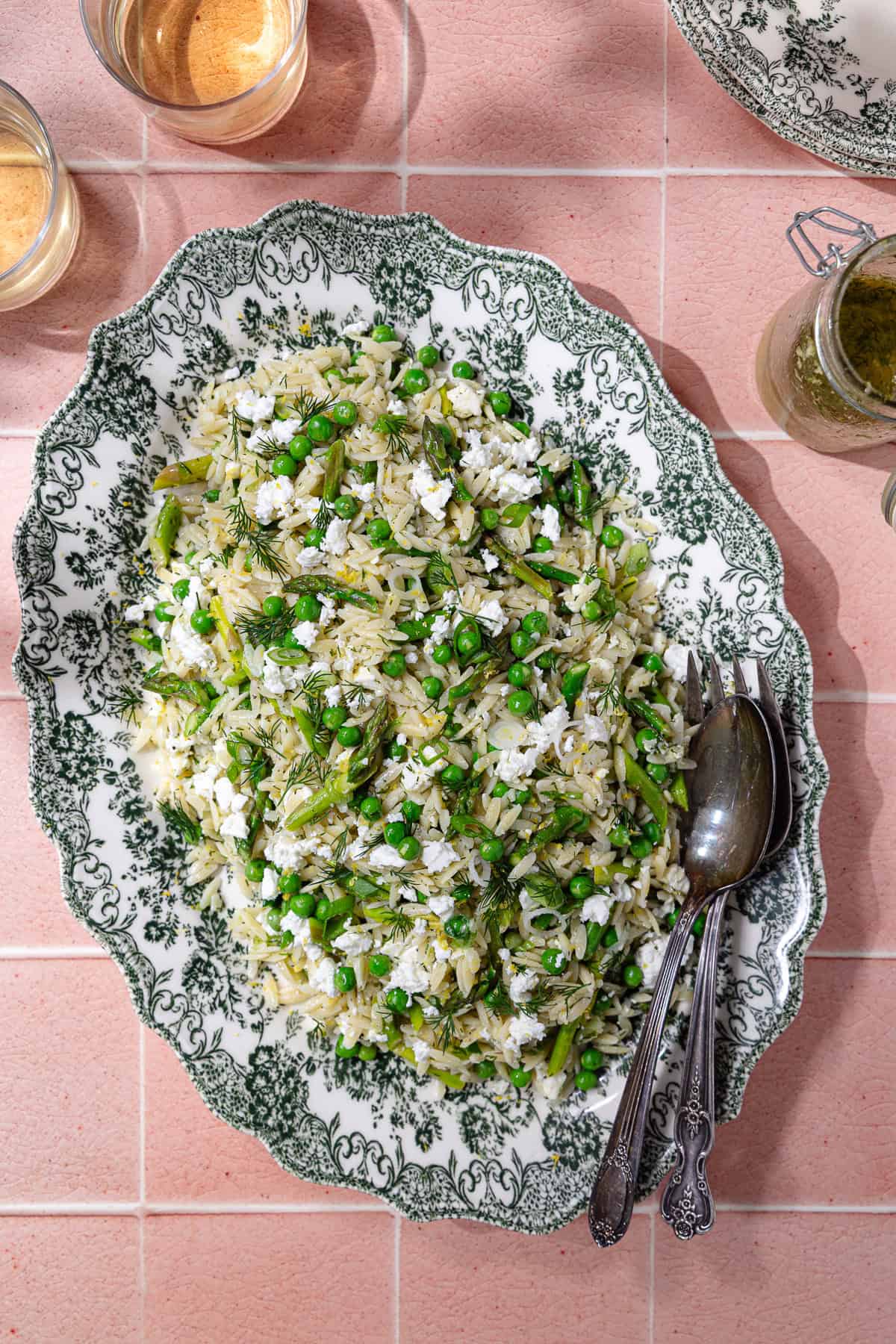 Spring orzo pasta salad on a serving plate.