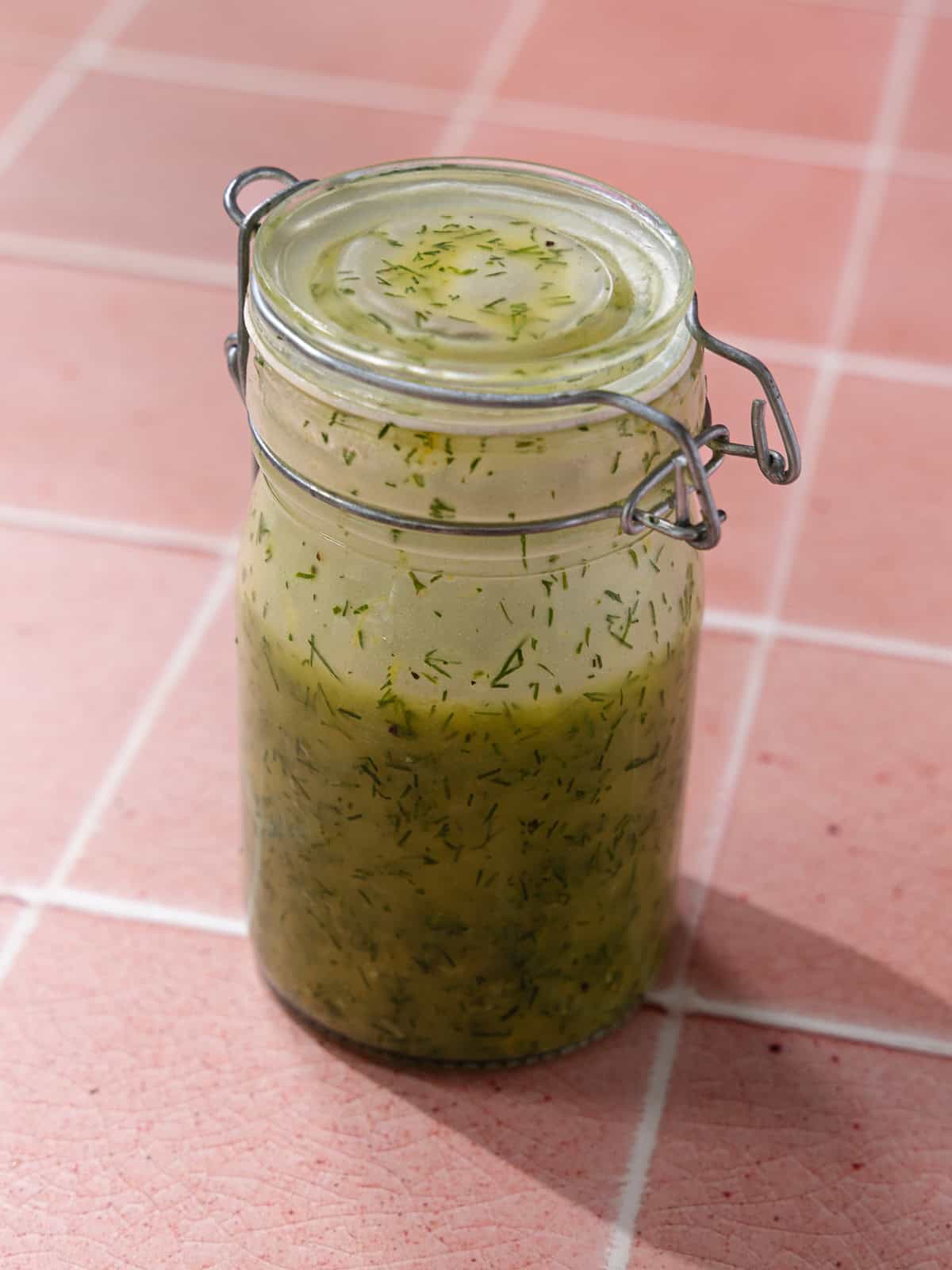 Lemon dill dressing in a jar.